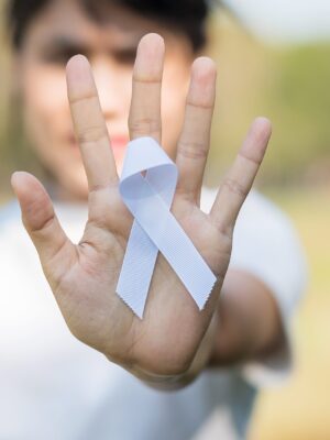 November Lung Cancer Awareness month, democracy and international peace day. Woman holding white Ribbon